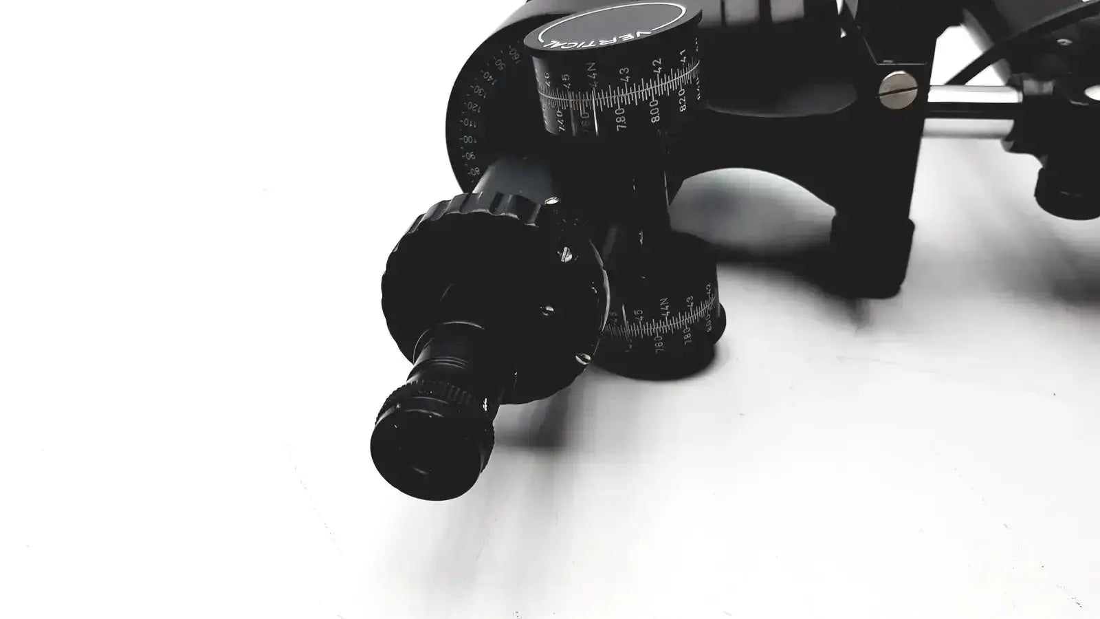 Black metal telescope mount with adjustable knobs and measurement markings on lombart instrument keratometer model 12515