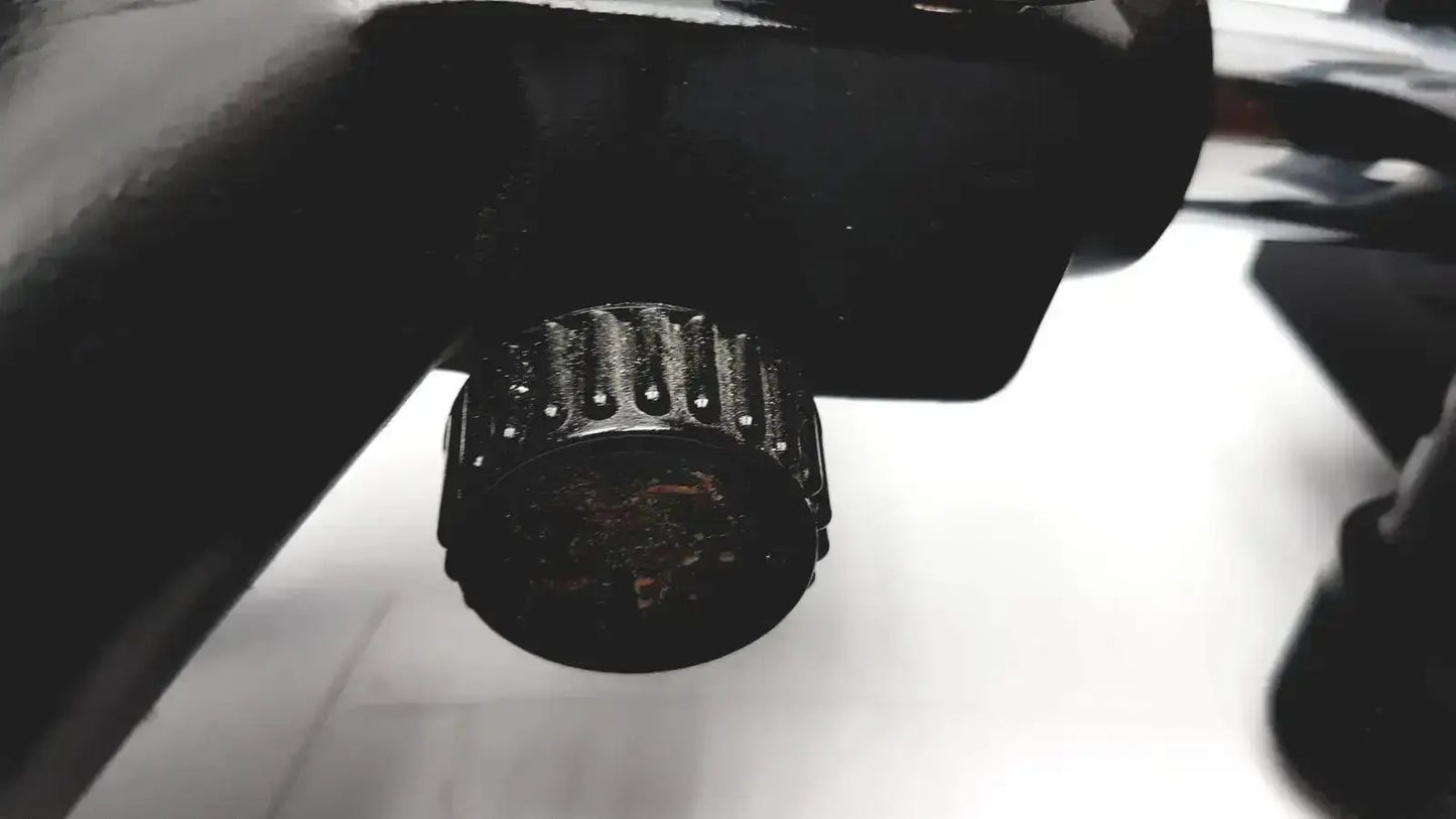 Black textured knob with ridged edges and worn finish on lombart instrument keratometer model 12515