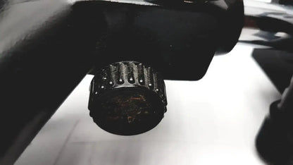 Black textured knob with ridged edges and worn finish on lombart instrument keratometer model 12515