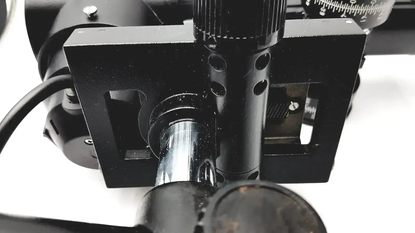 Black metal microscope stage with adjustable knobs and silver cylinder on lombart instrument keratometer model 12515