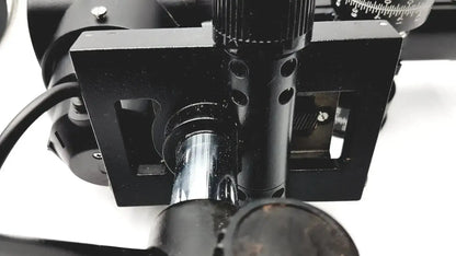 Black metal microscope stage with adjustable knobs and silver cylinder on lombart instrument keratometer model 12515