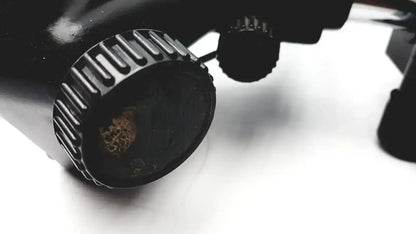 Black textured knob with worn rusted center on lombart instrument keratometer model 12515 for precise adjustments