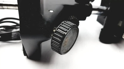 Black textured knob with ridged edges and embossed design on lombart instrument keratometer model 12515 face