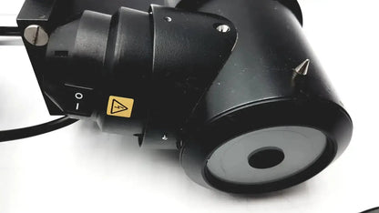 Black cylindrical matte microscope objective lens with yellow warning label and silver screws on lombart instrument keratometer model 12515