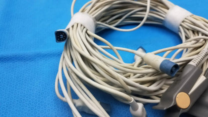 Coiled beige philips m1196a medical monitoring cables with black multi-pin connector and blue gray adult finger clip plugs