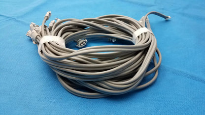 Coiled gray nibp air hose with multiple air hose fast connectors secured by white ties for double tube use
