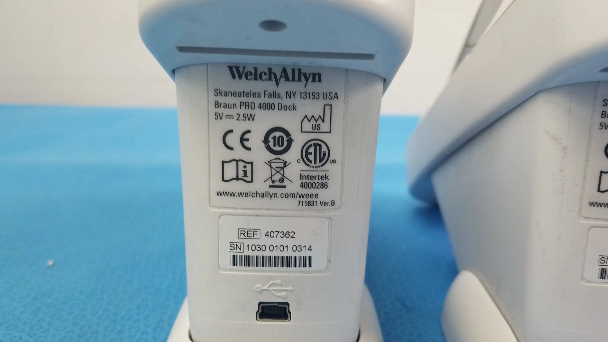 White plastic braun pro 4000 dock charging station with usb port and regulatory labels for reuse medical equipment