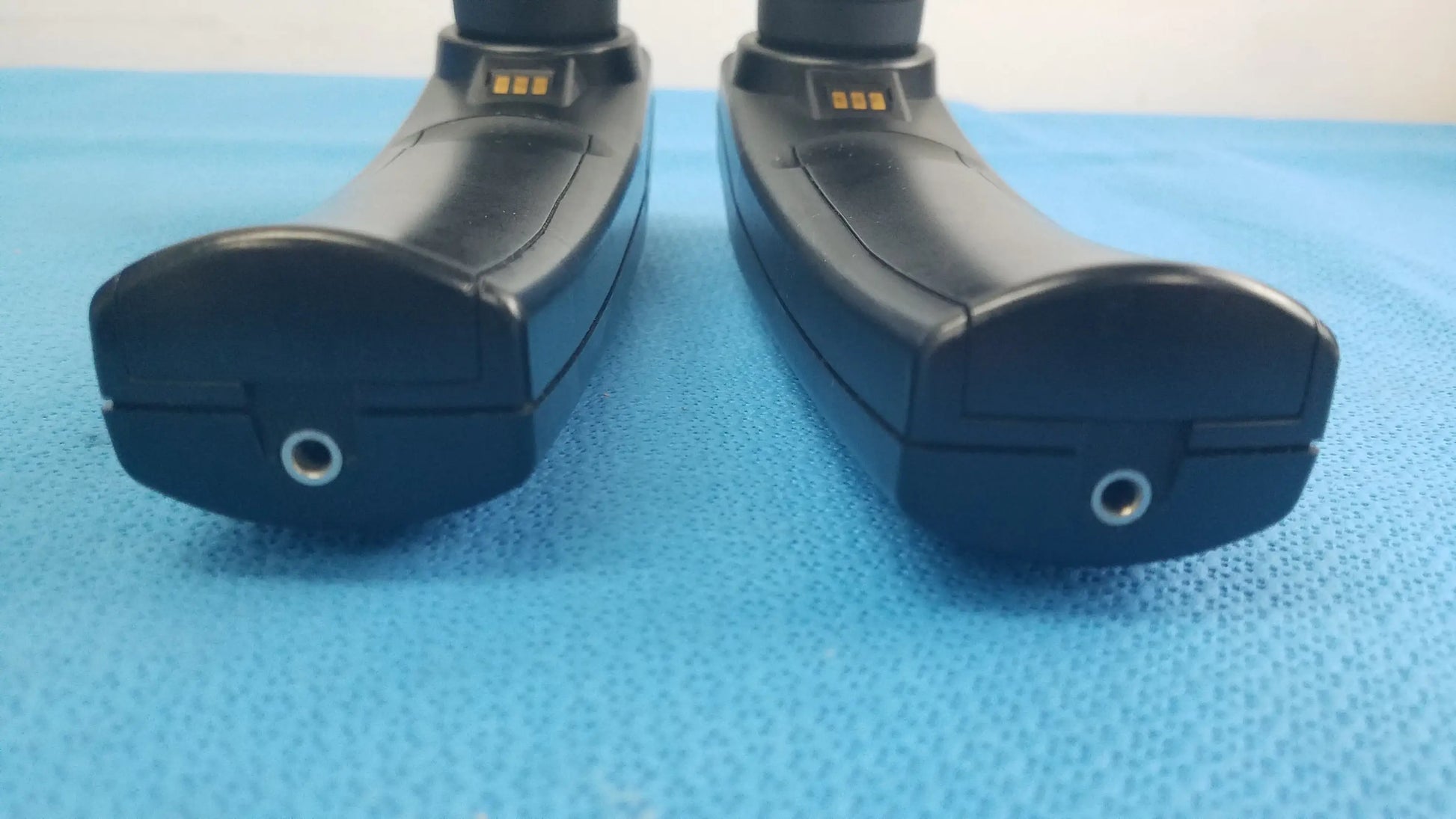 Lot of 2 maico ero scan pro handheld auditory devices with black ergonomic design metallic charging ports and gold contact strips for hearing screening medical equipment