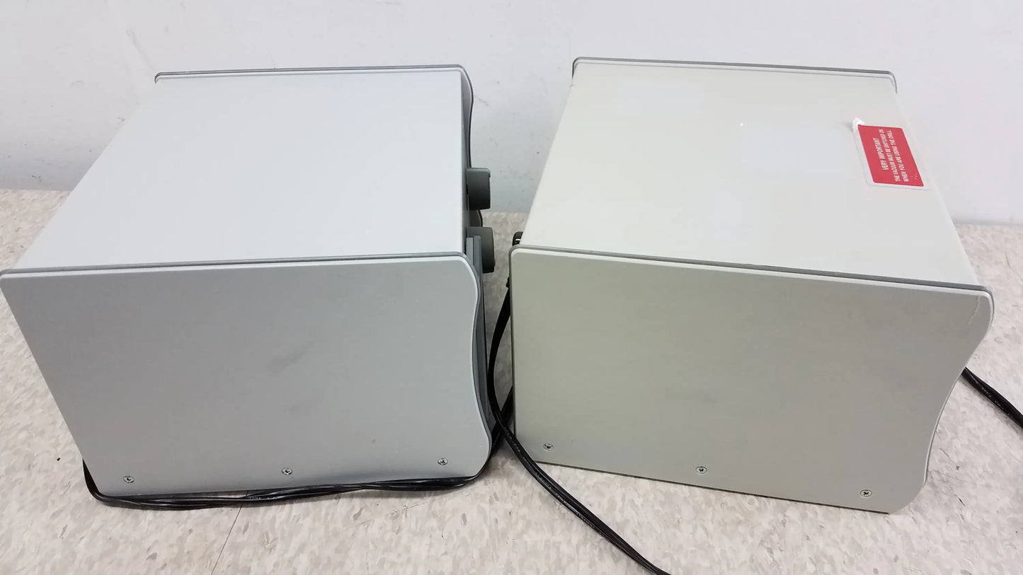 Two gray metal power supply units with black cables for reuse medical equipment stream ii podiatry drill