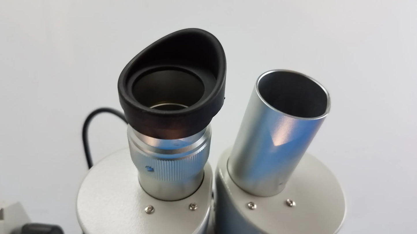 Black rubber eyepiece with silver metallic body on meiji techno stereo microscope for medical equipment use