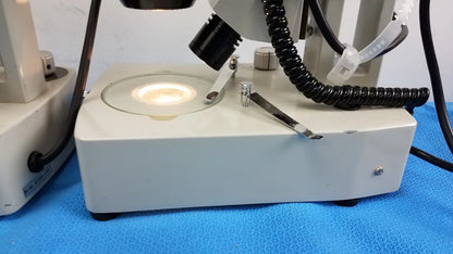 White rectangular base with circular glass stage and metallic parts of meiji techno stereo microscope medical equipment