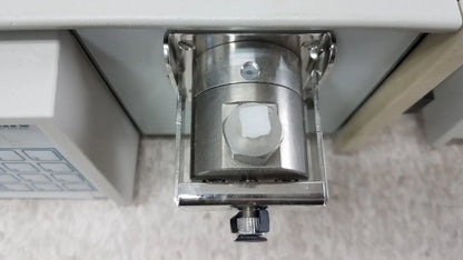 Silver metallic cylindrical solvent delivery system with hexagonal nut and adjustment knob for buy used medical equipment