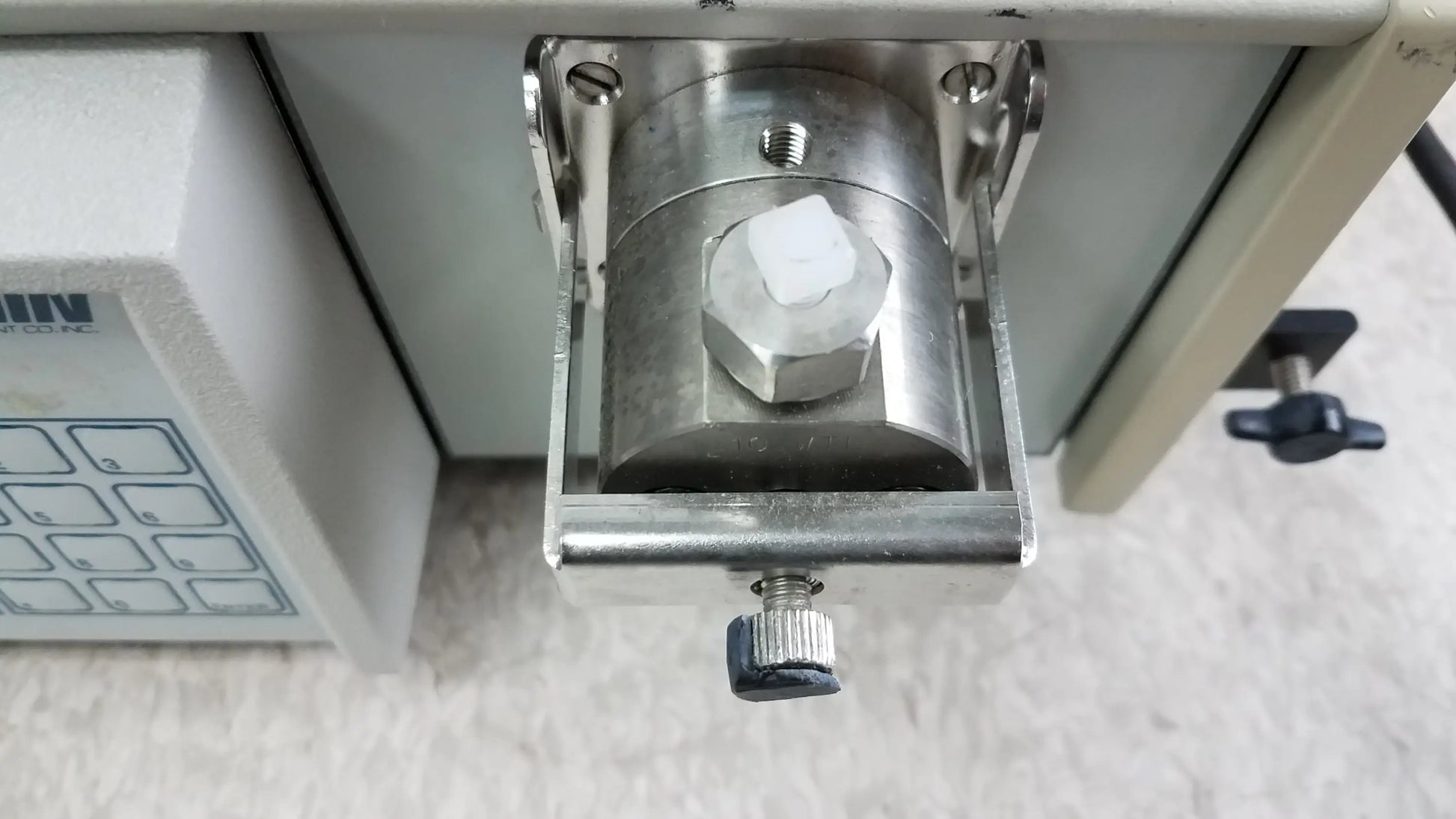 Silver metallic cylindrical component with hexagonal nut and threaded rod mounted on bracket in used medical equipment for sale lot of 2 rainin hpXL solvent delivery system