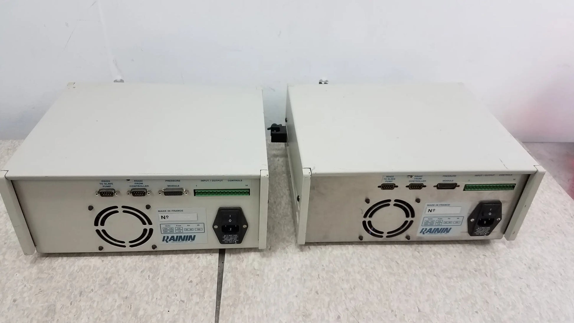 Two beige rainin hp xl solvent delivery systems showing back with ventilation grilles and ports for buy used medical equipment
