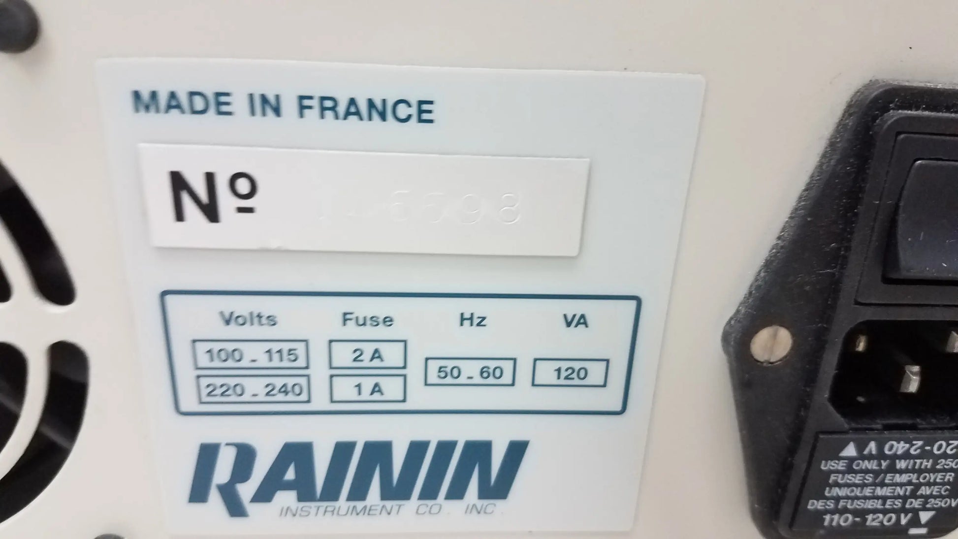 White rectangular label with black text and blue logo showing technical specifications for pre owned rainin hpxl solvent delivery system