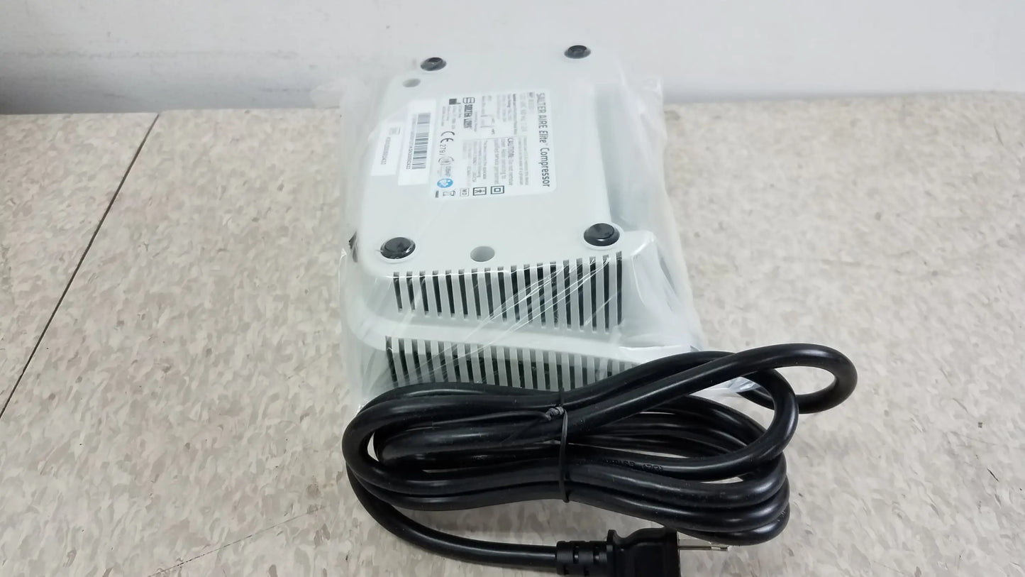 White plastic power adapter with black coiled cord and ventilation slits on the back for salter aire elite compressor nebulizer used medical equipment for sale