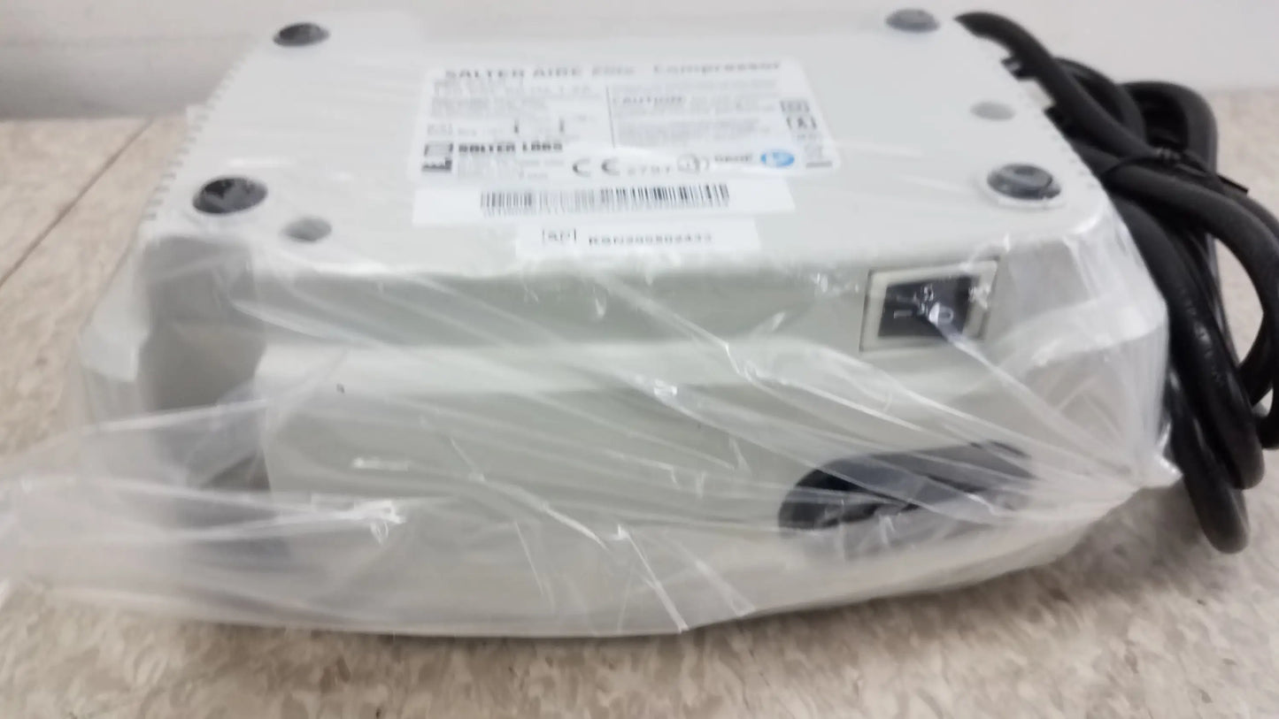 White plastic-wrapped Salter AIRE Elite Compressor Nebulizer System with black power cord for buy used medical equipment
