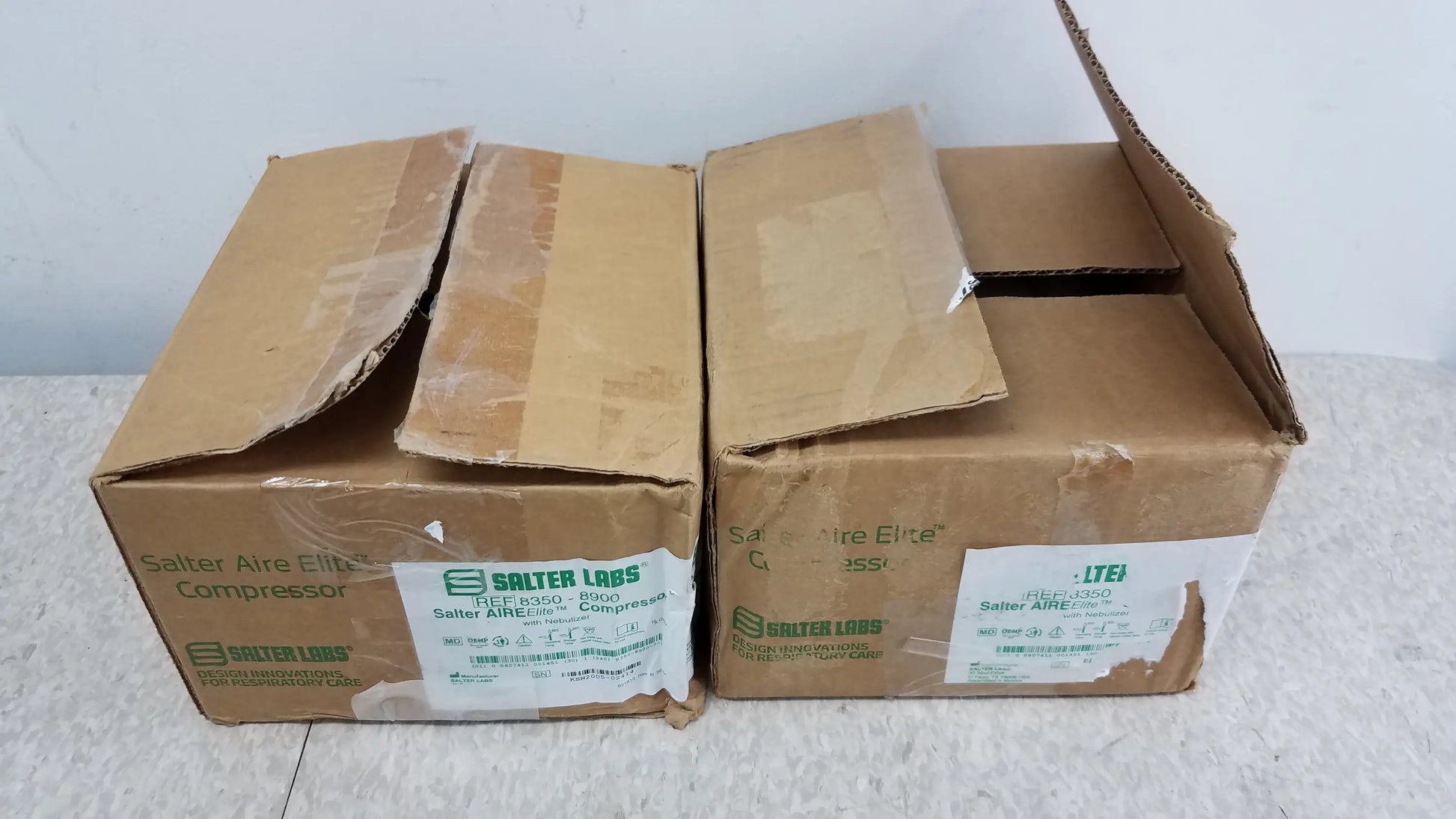 Two brown cardboard boxes of salter labs satter aire elite compressor nebulizer systems for buy used medical equipment