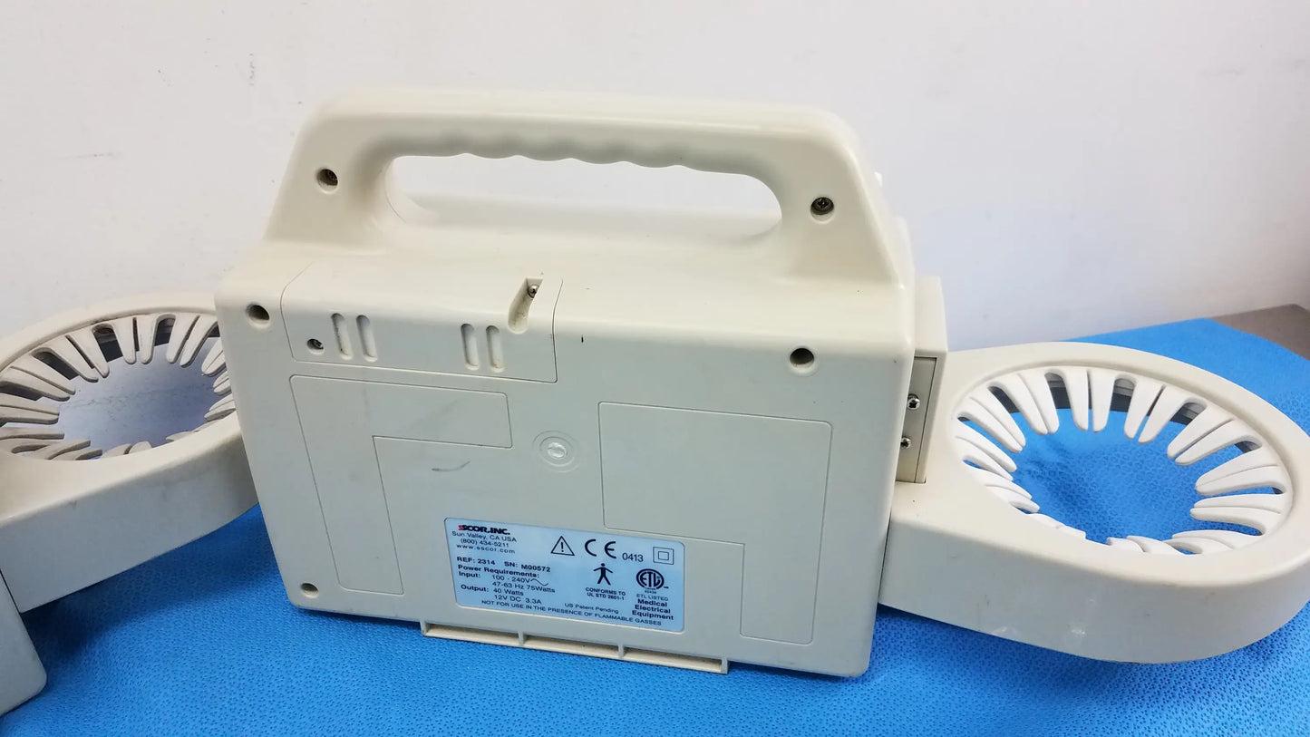 Beige plastic duet portable aspirator with integrated handle and circular arm attachments for medical equipment use