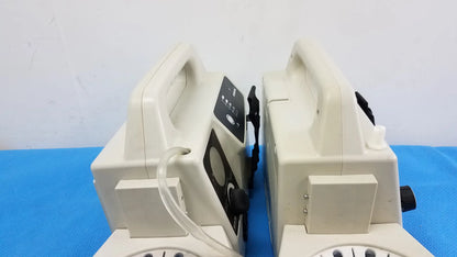 Lot of 2 beige SSCOR 2314 duet portable aspirators with black control panels on blue surface medical equipment