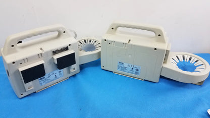 Two beige sscor 2314 duet portable aspirators with handle tops and circular fan attachments for medical equipment use