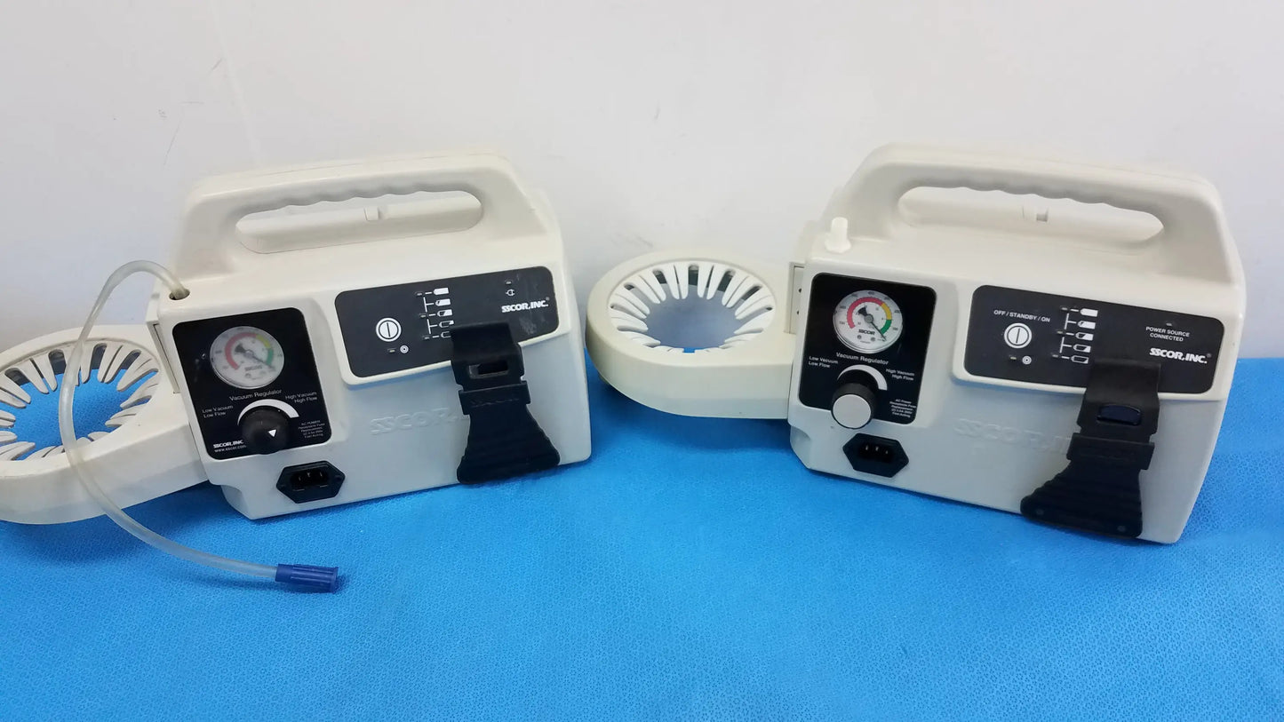 Two white portable aspirator units with black control panels and pressure gauges by Secor Inc duet portable aspirator medical equipment