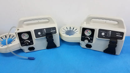 Two white portable aspirator units with black control panels and pressure gauges by Secor Inc duet portable aspirator medical equipment