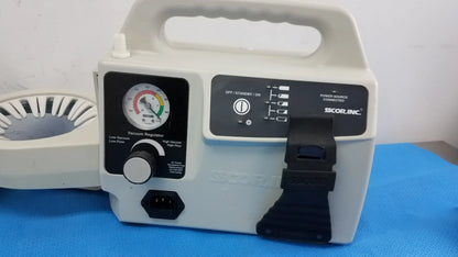 White plastic medical portable aspirator with black control panel and handle branded scor inc for duet portable aspirator use