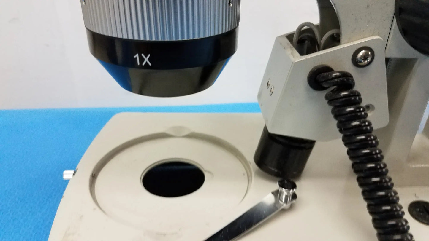 Silver and black 1x magnification objective lens with ribbed focus ring for stereo microscope and inverted binocular microscope