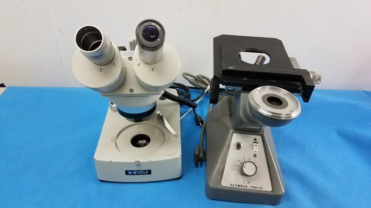 Gray and white olympus tokyo stereo microscope with dual eyepieces and adjustable stage in stereo microscope set