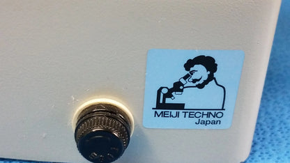 Beige stereo microscope with black knurled knob and blue meiji techno japan logo in a lot of 2 inverted binocular set