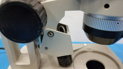Silver and black inverted binocular microscope with textured focus knobs included in lot of 2 stereo microscope set