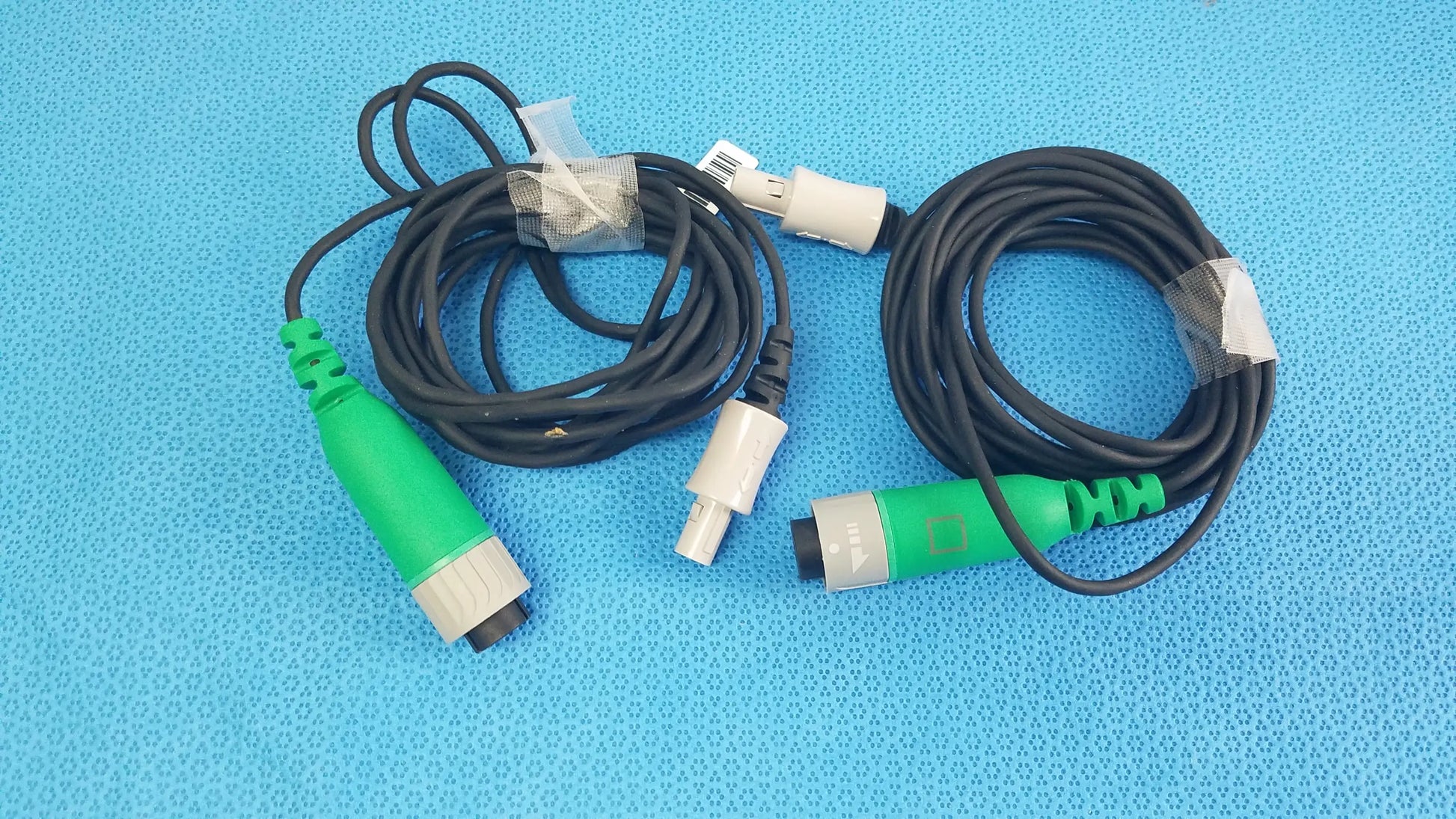 Lot of 2 Stryker catheter connector cables with black coiled cables and green and gray connectors for medical equipment reuse