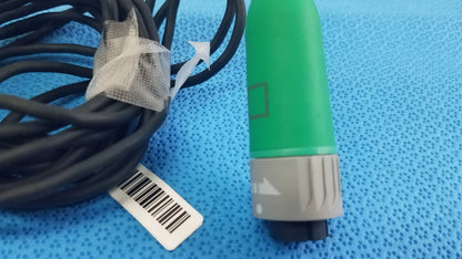 Green and gray fiber optic stryker catheter connector with black cable coiled for reuse medical equipment use