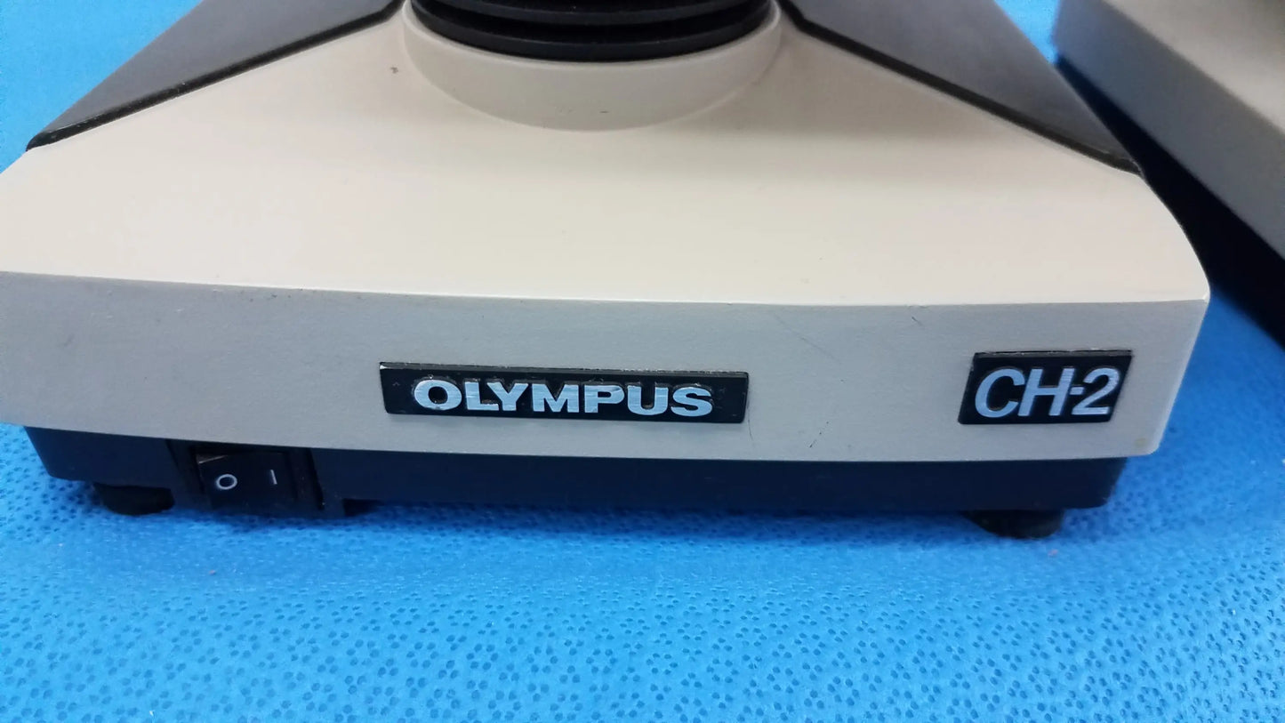 Beige and black Olympus CH-2 microscope base with power switch for reuse medical equipment in laboratory settings
