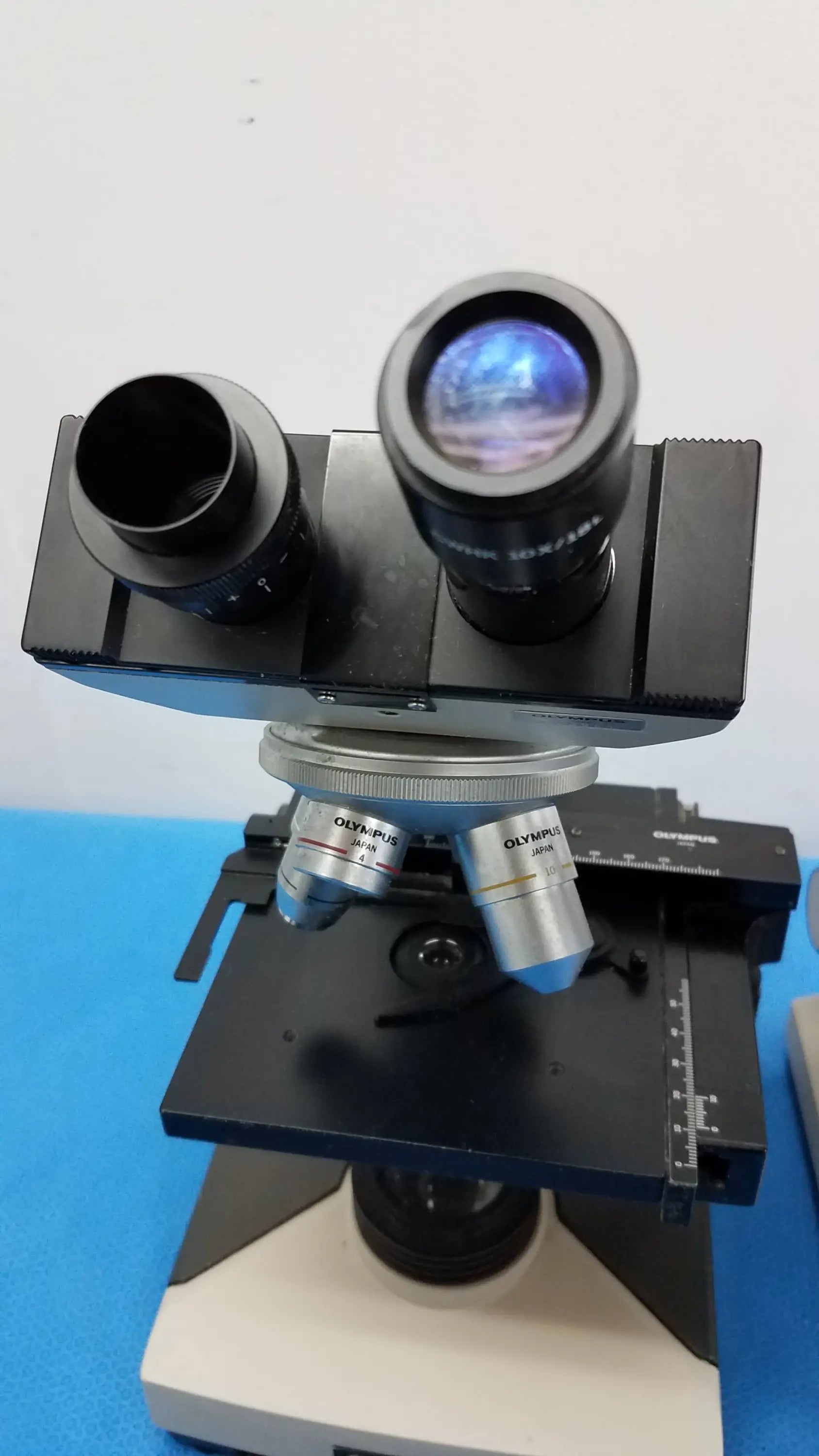 Black and silver Olympus CH-2 compound microscope with dual eyepieces for reuse medical equipment in laboratory use