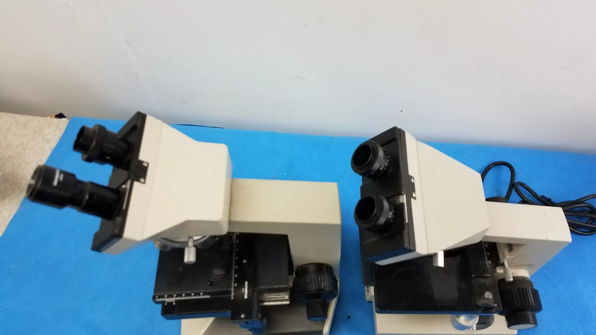 Lot of 2 beige and black wesco and olymus ch2 compound microscopes with dual eyepieces for reuse medical equipment