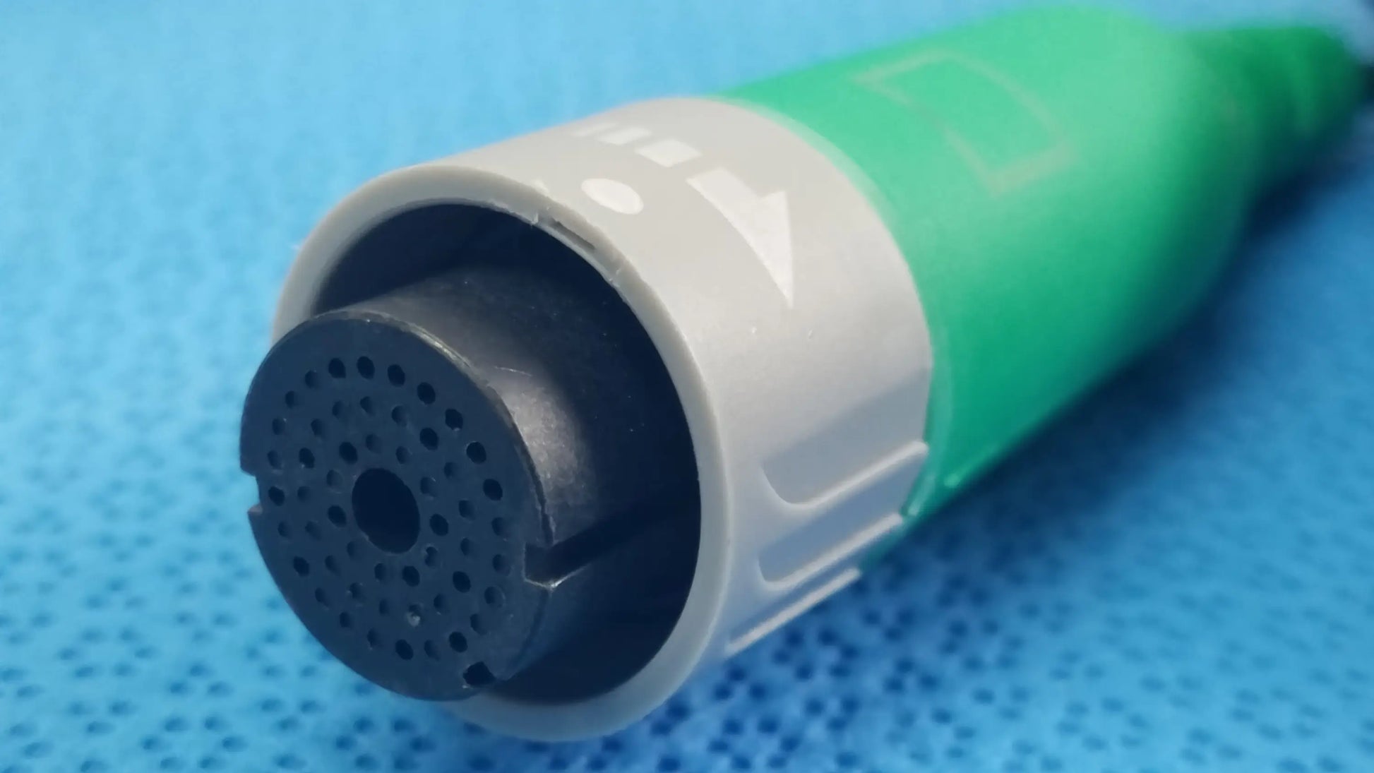 Green and gray medical-grade Ensite X EP system connector cable with black perforated end cap for reuse medical equipment