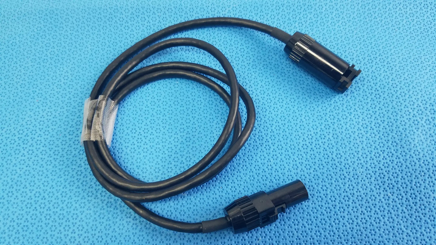 Black coiled mc4 solar connector extension cable with two black plastic connectors for reuse medical equipment applications