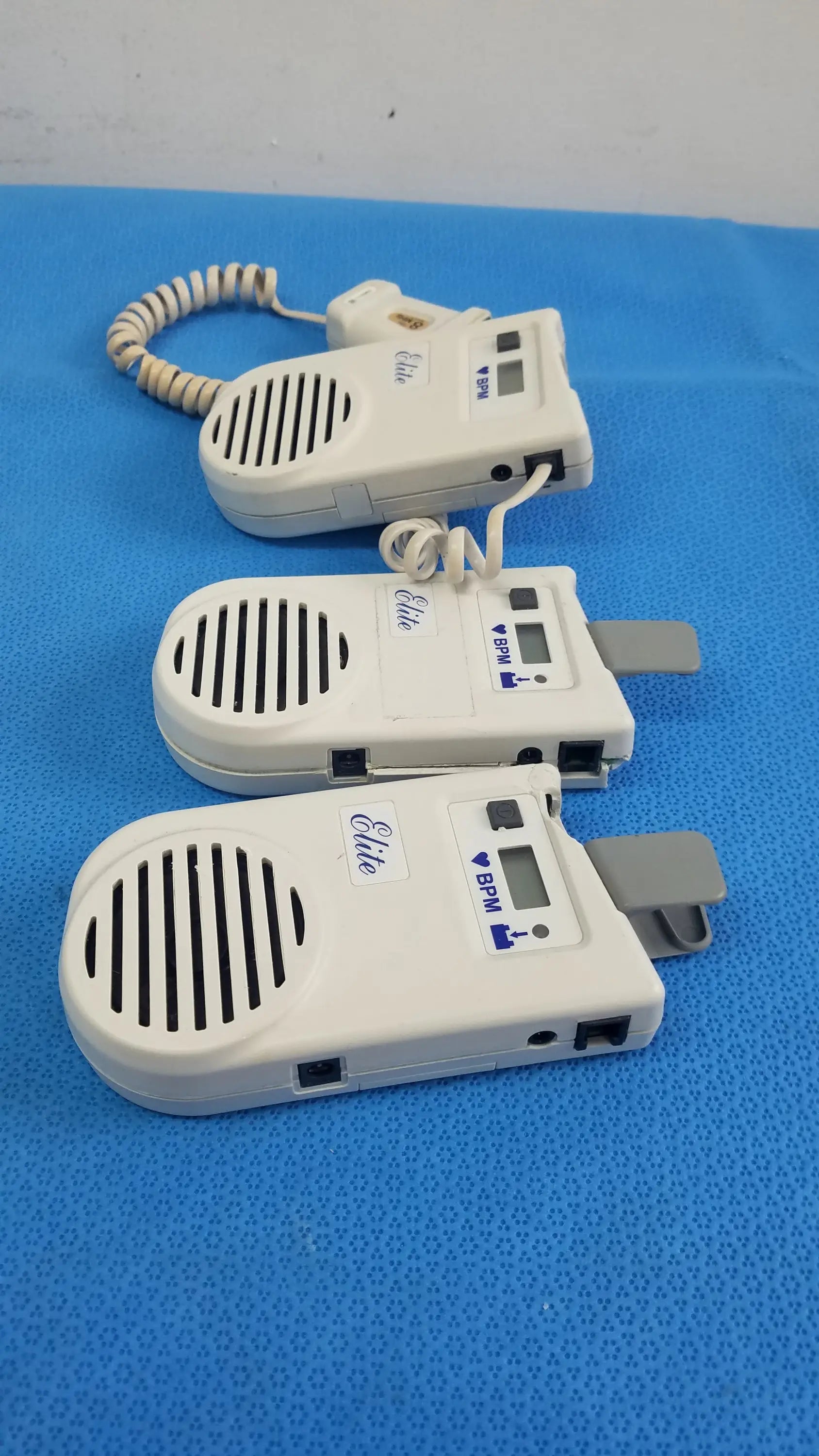 Lot of 3 white plastic natus neurology elite 200r handheld dopplers with coiled cords and digital displays medical equipment