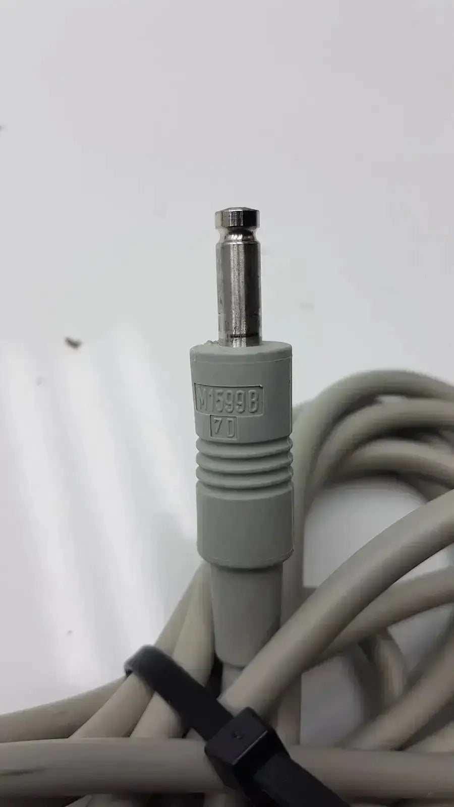 Gray medical-grade philips nibp air hose m1599b 7d adult cable connector with metallic plug and embossed model number