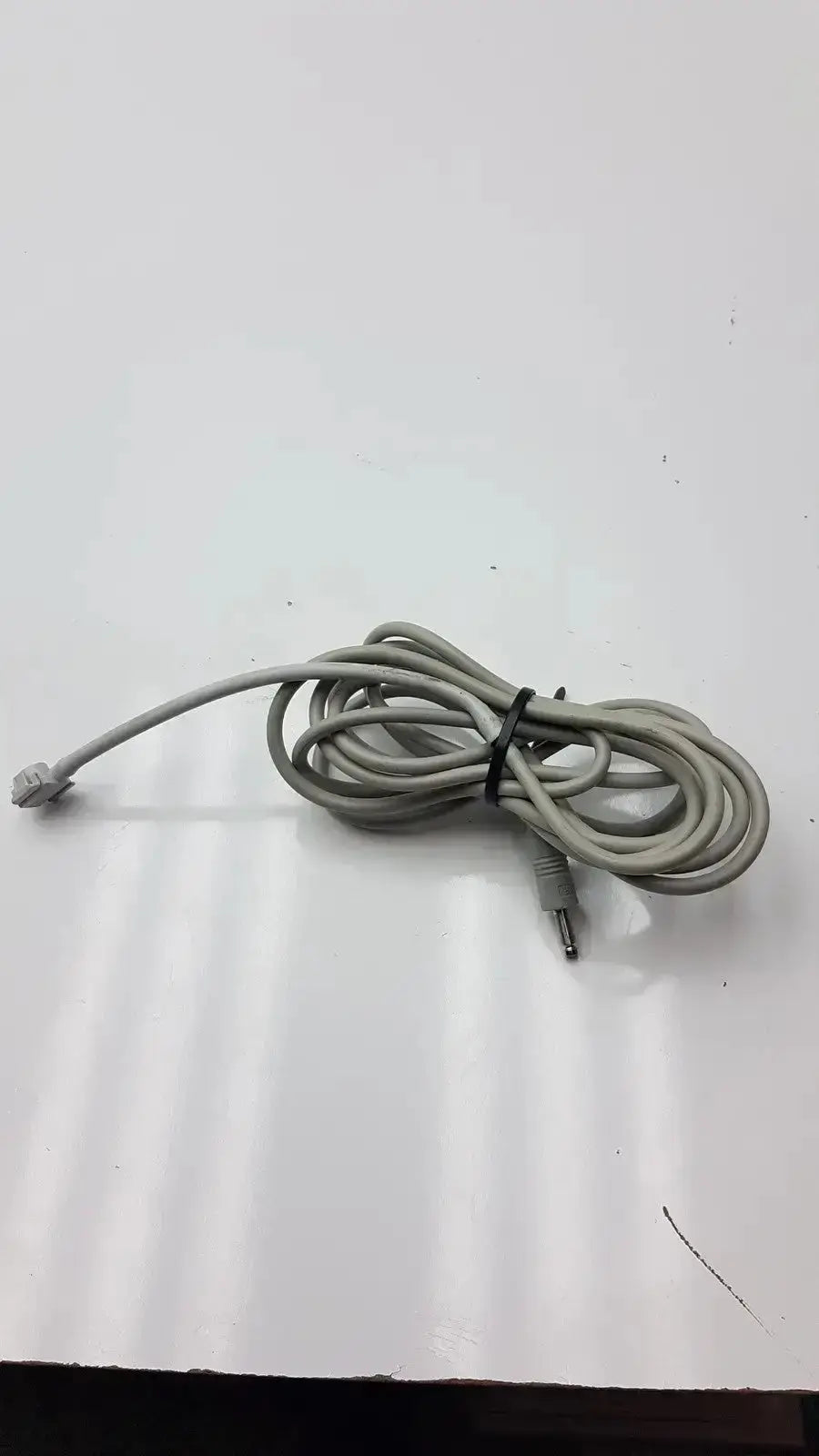 Gray coiled audio cable with 3.5mm jack and rca connector tied with black zip tie for philips nibp air hose m1599b 7d adult