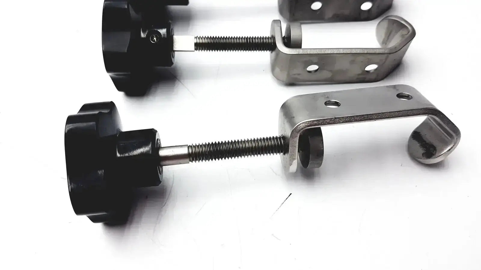 Black plastic knob with threaded metal rod and silver stainless steel bracket for tube slot pipe i-beam clamp