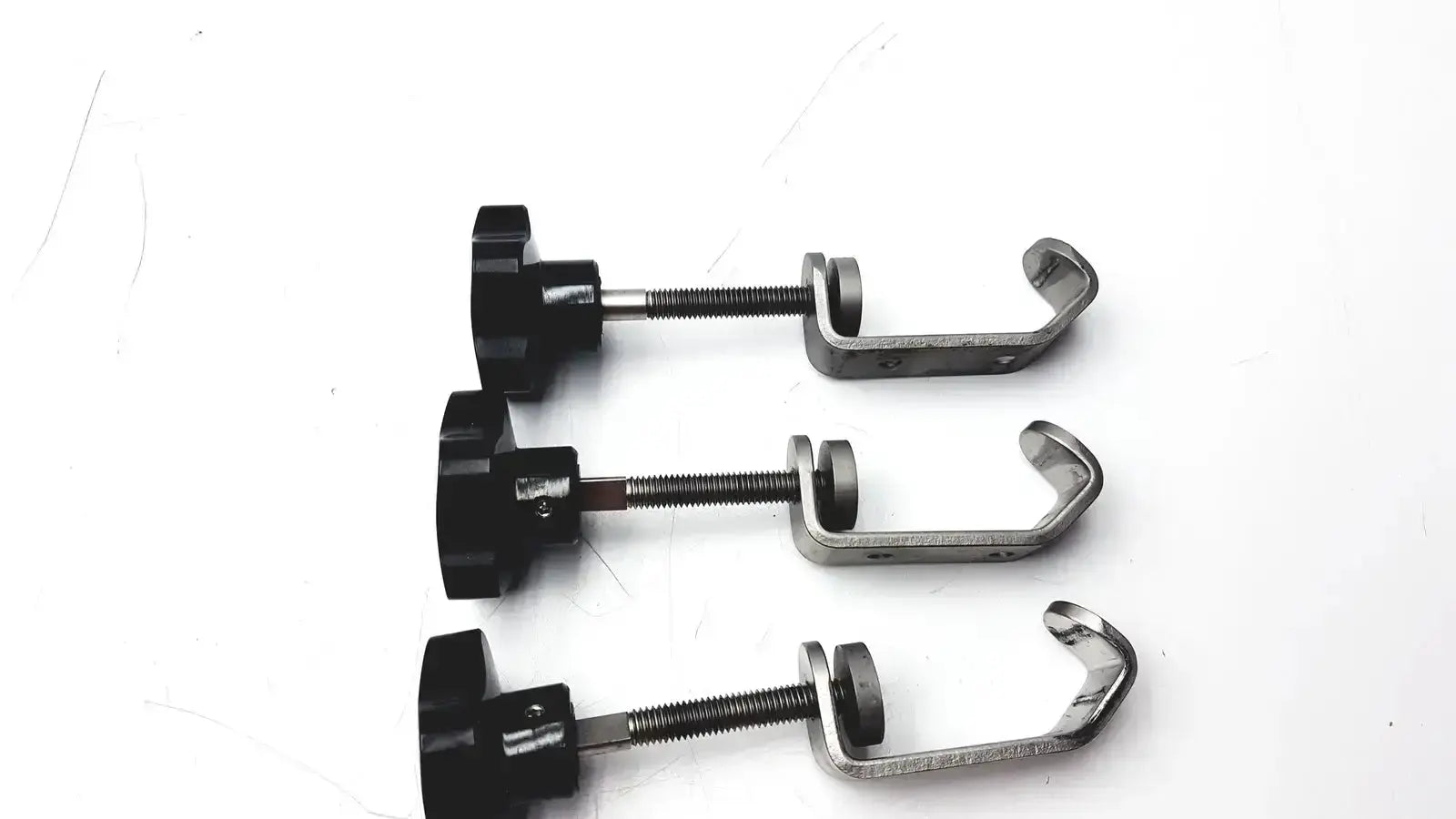 Black plastic knob with threaded metal rod and u-shaped stainless steel clamp for tube slot pipe fixture I-beam clamp