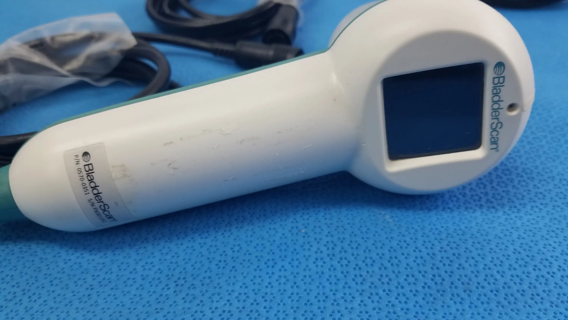 White plastic verathon bladderscan handheld ultrasound device with green accents for reuse medical equipment use