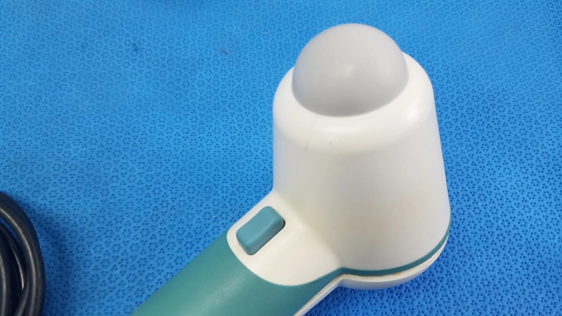 White and teal verathon bladderscan handheld ultrasound probe with rounded dome-shaped tip for reuse medical equipment