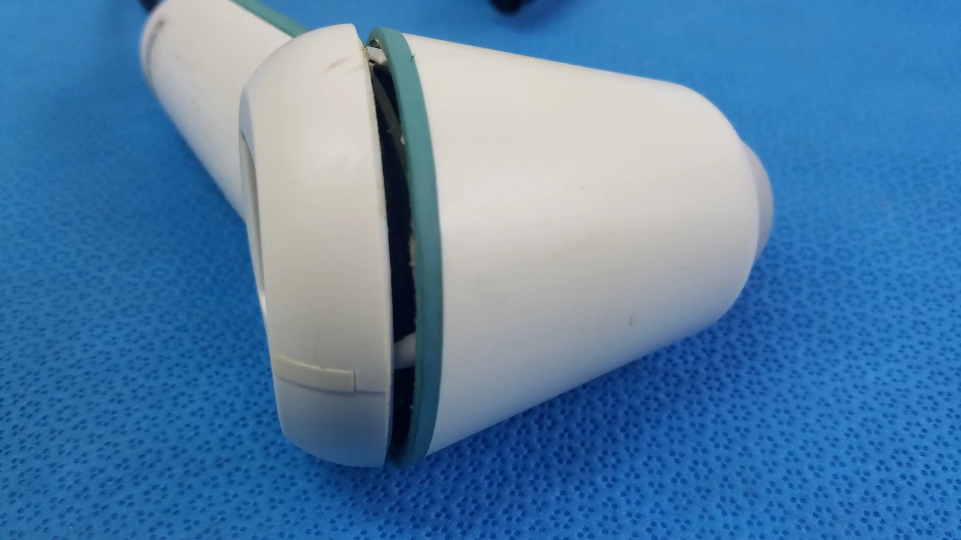 White plastic handheld verathon bladderscan ultrasound probe with teal accent ring and internal wiring for reuse medical equipment