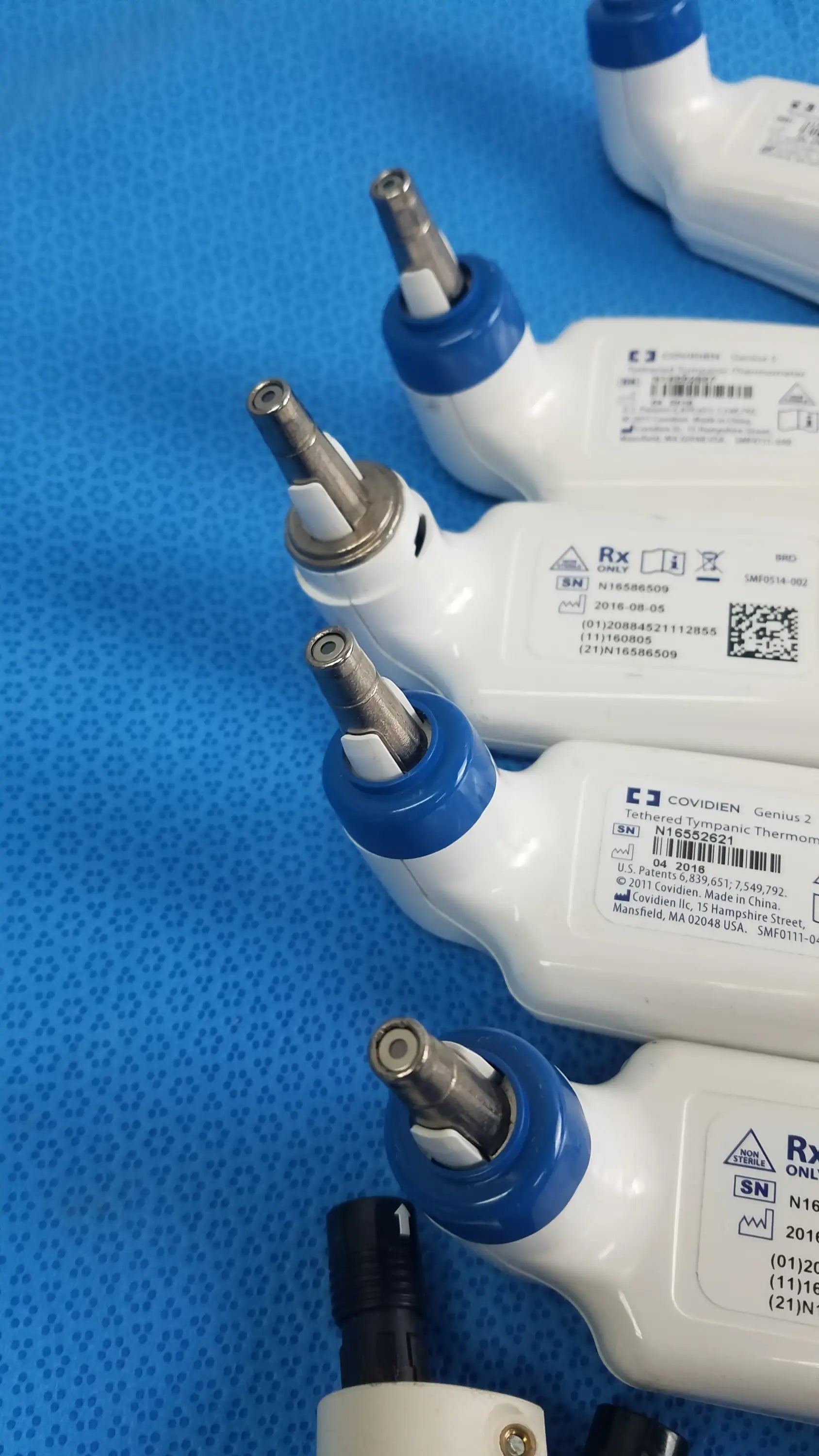 Lot of 4 covidien genius 2 tethered tympanic thermometers white and blue medical equipment with metallic tips for reuse medical use
