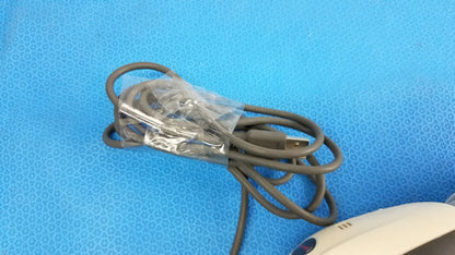 A coiled gray usb cable wrapped in clear plastic for a lot of 4 laser barcode scanner readers used in medical equipment