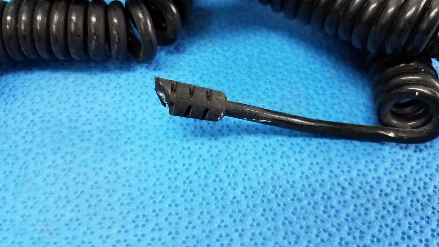 Black coiled cord with frayed connector end for wall transformer ideal for reuse medical equipment assemblies